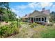 A charming home with lush landscaping, a cozy seating area, and a welcoming bay window filled with plants at 2020 E Dolphin Dr, Englewood, FL 34223
