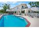 The exterior of the home is complemented by a lovely pool and lots of lounge seating at 2020 E Dolphin Dr, Englewood, FL 34223