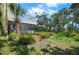 The home features a screened porch, landscaping, and a blend of natural and manicured outdoor spaces at 2020 E Dolphin Dr, Englewood, FL 34223