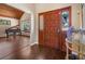 Elegant foyer with hardwood floors, a wooden door, and a view into the living room with a piano at 2020 E Dolphin Dr, Englewood, FL 34223