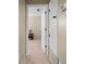 Hallway view with neutral colors and access to other rooms at 2020 E Dolphin Dr, Englewood, FL 34223