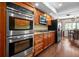 Kitchen with stainless steel appliances, granite counters, wood cabinets, and dining area at 2020 E Dolphin Dr, Englewood, FL 34223
