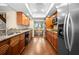 Updated kitchen features granite countertops, wood cabinets, stainless steel appliances, and recessed lighting at 2020 E Dolphin Dr, Englewood, FL 34223