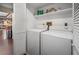 Functional laundry room with shelving and washer and dryer at 2020 E Dolphin Dr, Englewood, FL 34223