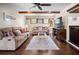 Cozy living room with ceiling fan, wood beams, and comfortable seating at 2020 E Dolphin Dr, Englewood, FL 34223