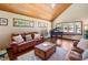 Spacious living room with a grand piano, comfortable leather seating, and a cozy, inviting atmosphere at 2020 E Dolphin Dr, Englewood, FL 34223
