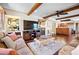 Open-concept living room with a view to the kitchen and natural light at 2020 E Dolphin Dr, Englewood, FL 34223