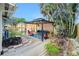 Backyard retreat with outdoor furniture, a grill, and lush landscaping for relaxation and entertainment at 221 Nippino E Trl, Nokomis, FL 34275