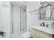 Modern bathroom featuring a glass-enclosed shower and decorative mirror above the sink at 221 Nippino E Trl, Nokomis, FL 34275