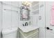 Elegant bathroom showcasing decorative mirror and a white vanity with sleek black fixtures at 221 Nippino E Trl, Nokomis, FL 34275