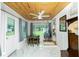 Bright dining room features wood ceiling, unique swing chair, and a view of the backyard through large windows at 221 Nippino E Trl, Nokomis, FL 34275