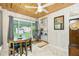 Bright dining room with wooden ceiling, swing chair, table for four, and large sliding window with a backyard view at 221 Nippino E Trl, Nokomis, FL 34275