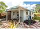View of an exterior of house with awning, patio and checkered brick at 221 Nippino E Trl, Nokomis, FL 34275