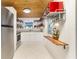 Galley kitchen with modern stainless steel appliances, white cabinetry, and open shelving at 221 Nippino E Trl, Nokomis, FL 34275