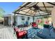 Comfortable shaded patio with furniture, a grill, and outdoor seating, perfect for relaxation and entertaining at 221 Nippino E Trl, Nokomis, FL 34275