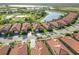 Aerial view of the community showcasing lakes, landscaping, and tile roofs at 24181 Gallberry Dr, Venice, FL 34293