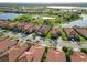 Lakeside community with well-maintained landscaping and homes with tile roofs seen from an aerial view at 24181 Gallberry Dr, Venice, FL 34293