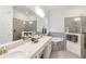 Spa-like bathroom features a soaking tub, walk-in shower, dual sinks, and modern fixtures at 24181 Gallberry Dr, Venice, FL 34293