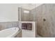Elegant bathroom featuring a shower with glass surround and a soaking tub at 24181 Gallberry Dr, Venice, FL 34293