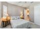 Bedroom with light color walls, shutters on window, neutral bedding, and carpet flooring at 24181 Gallberry Dr, Venice, FL 34293