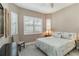 Bedroom with large window with shutters, light color walls, and neutral color bedding at 24181 Gallberry Dr, Venice, FL 34293