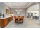 Dining area featuring modern light fixture, stylish decor and seamless flow to kitchen at 24181 Gallberry Dr, Venice, FL 34293