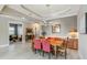 Open dining room with modern lighting and stylish furniture next to an adjoining living space at 24181 Gallberry Dr, Venice, FL 34293
