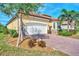 Side view showcasing the home's stucco exterior, red tile roof, and well-maintained landscaping at 24181 Gallberry Dr, Venice, FL 34293