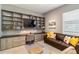 Well-appointed office with custom built-ins, granite counters, and comfortable seating at 24181 Gallberry Dr, Venice, FL 34293