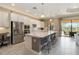 Bright kitchen with a large island, stainless appliances, and seamless access to the outdoor living space at 24181 Gallberry Dr, Venice, FL 34293