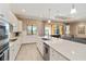 Modern kitchen features a large island, stainless appliances, and is open to the adjacent living spaces at 24181 Gallberry Dr, Venice, FL 34293