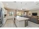 This kitchen features an expansive island, stainless appliances, and is open to the living area at 24181 Gallberry Dr, Venice, FL 34293