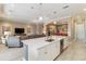 Open-concept kitchen features an island with a sink, stainless appliances, and seamless flow to the living areas at 24181 Gallberry Dr, Venice, FL 34293
