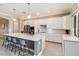 Open kitchen boasts a large island with seating, stainless appliances, and ample cabinet space at 24181 Gallberry Dr, Venice, FL 34293