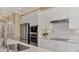 This modern kitchen features stainless steel appliances, white cabinets, and a tile backsplash at 24181 Gallberry Dr, Venice, FL 34293