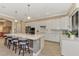 Spacious kitchen with white cabinetry, stainless steel appliances, and a large island with seating at 24181 Gallberry Dr, Venice, FL 34293