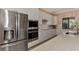 Modern kitchen featuring stainless steel appliances, white cabinets, and quartz countertops at 24181 Gallberry Dr, Venice, FL 34293