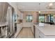 Bright kitchen featuring white cabinets, stainless steel appliances, and a large center island at 24181 Gallberry Dr, Venice, FL 34293