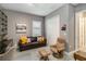Comfortable living area showcasing a brown leather sofa, a recliner, and natural light, offering relaxation and style at 24181 Gallberry Dr, Venice, FL 34293