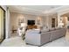 Spacious living room with neutral decor, large sectional and an open floor plan at 24181 Gallberry Dr, Venice, FL 34293