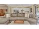 Comfortable living area with open view to kitchen; features a large sectional sofa and neutral decor at 24181 Gallberry Dr, Venice, FL 34293