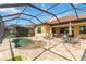 Inviting screened-in pool area with a spa, patio seating, and a glimpse of the well-maintained backyard at 24181 Gallberry Dr, Venice, FL 34293