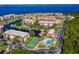 An aerial view of the property highlighting the pool, tennis court, boat docks, and tranquil bay views at 25188 Marion Ave # D308, Punta Gorda, FL 33950