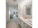 Bright bathroom with white vanity, sink, and view into spacious bedroom at 25188 Marion Ave # D308, Punta Gorda, FL 33950