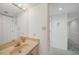 Bright bathroom features a large sink and vanity and access to a hallway with closets at 25188 Marion Ave # D308, Punta Gorda, FL 33950
