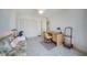Neutral bedroom featuring a ceiling fan, closet, and small desk setup at 25188 Marion Ave # D308, Punta Gorda, FL 33950