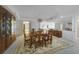 A formal dining room features a wooden table with seating for six, chandelier, and a mirrored wall at 25188 Marion Ave # D308, Punta Gorda, FL 33950