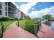 Waterfront condo complex features a private dock leading to boat slips and the main building at 25188 Marion Ave # D308, Punta Gorda, FL 33950