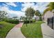 Scenic walkway and dock with lush landscaping in waterfront condo complex with boat slips at 25188 Marion Ave # D308, Punta Gorda, FL 33950