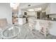 Bright kitchen features white cabinets, gray countertops, stainless appliances, and a cozy breakfast nook at 25188 Marion Ave # D308, Punta Gorda, FL 33950